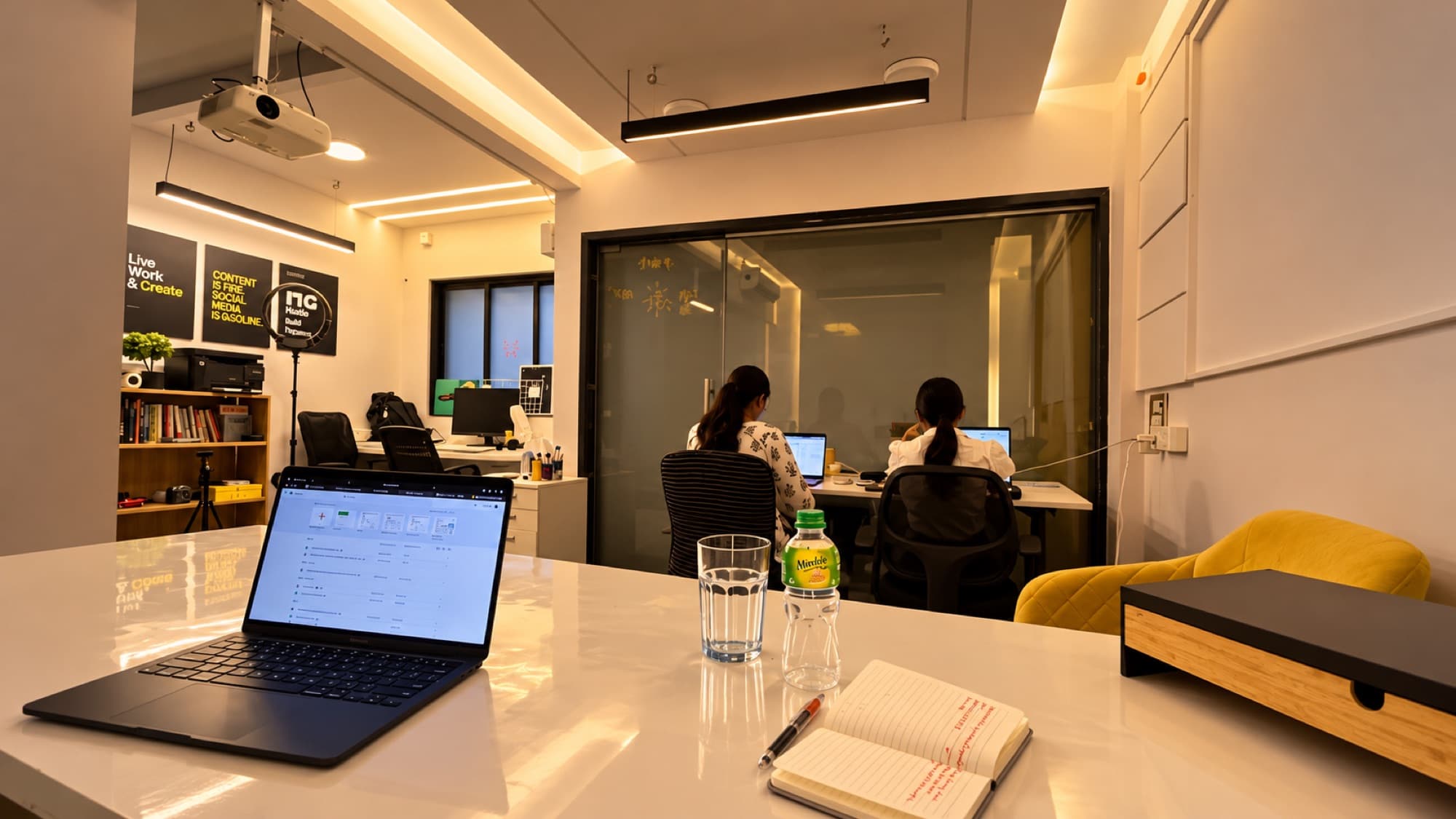 The Genesis Coworking floor: shared workstations and the glass-walled meeting room